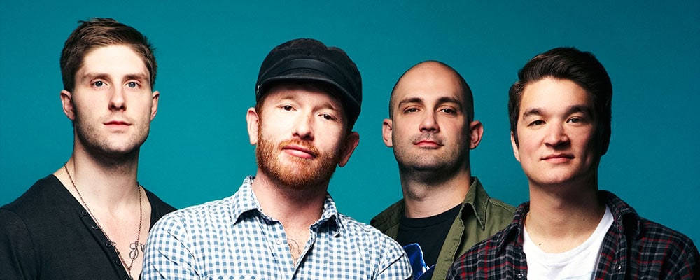 Tallahassee rock band Go Radio poses in front of blue background. (from left to right) guitarist Alex Reed, vocalist/guitarist Jason Lancaster, bassist Matt "Burns" Poulos, drummer Steven Kopacz.